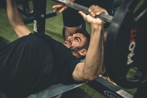 men pushing on the benchpress